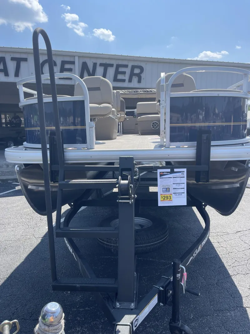 Slide: The Image of 2025 Sun Tracker Bass Buggy 18 DLX pontoon boat at dealership. - 2