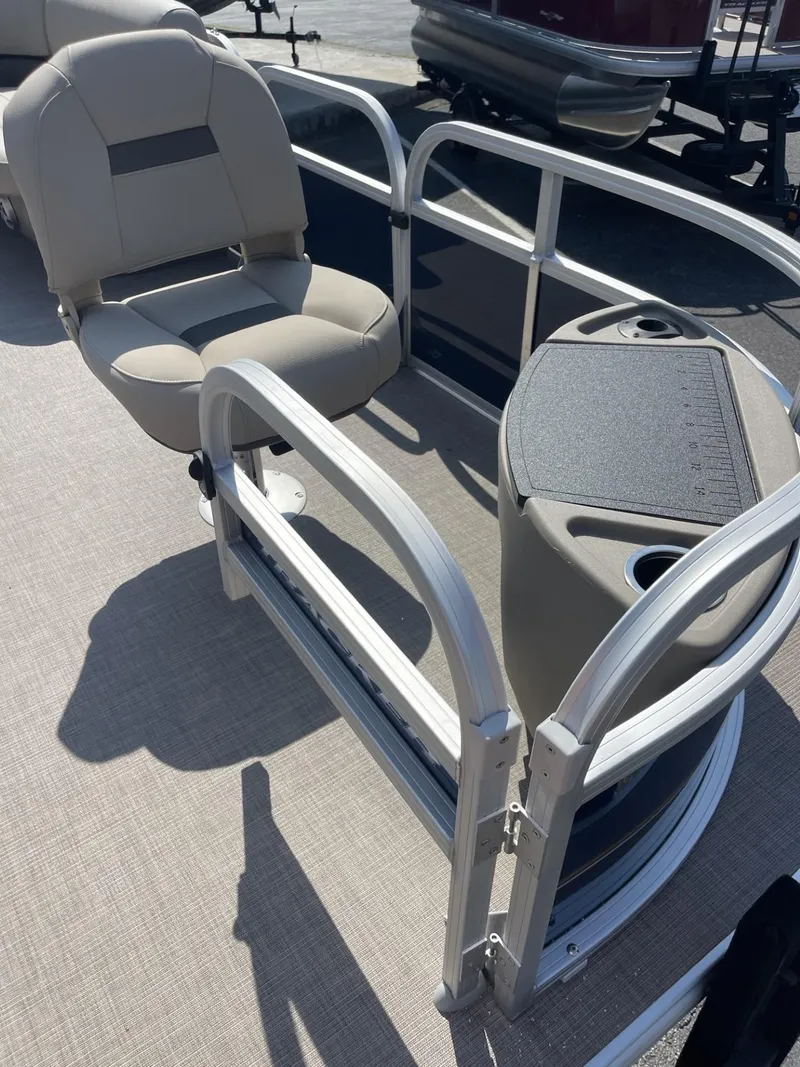 Slide: The Image of 2025 Sun Tracker Bass Buggy 18 DLX pontoon boat interior with seating and table. - 6