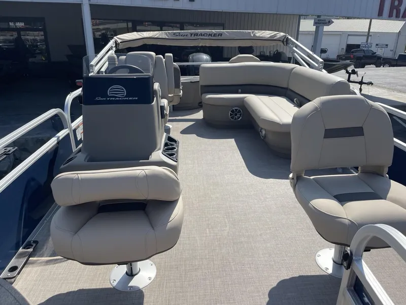 Slide: The Image of 2025 Sun Tracker Bass Buggy 18 DLX pontoon boat with beige seating and spacious deck. - 7