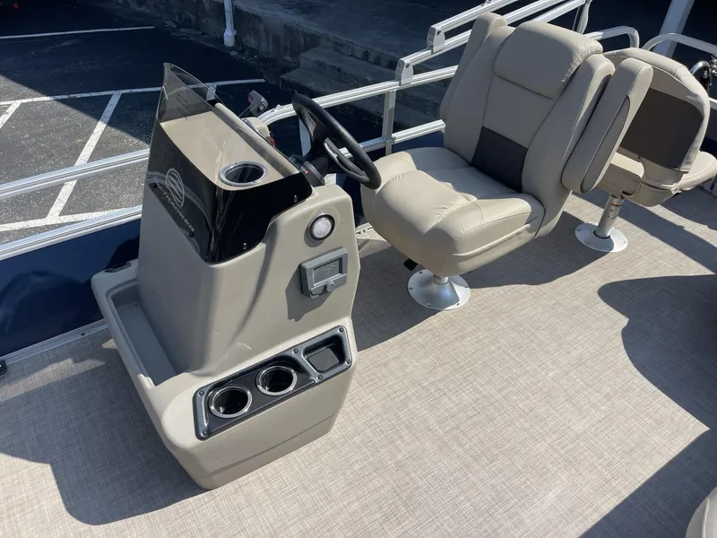 Slide: The Image of 2025 Sun Tracker Bass Buggy 18 DLX pontoon boat interior with captain's chair and console. - 8