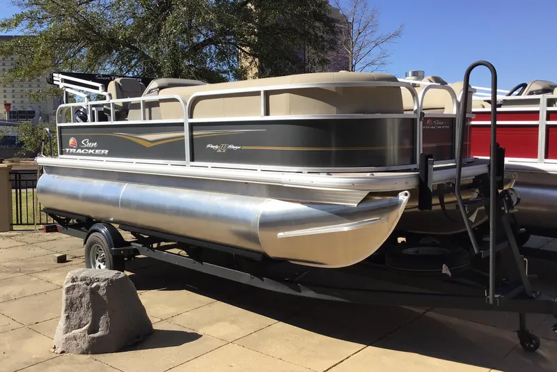 The Image of 2025 Sun Tracker Party Barge 18 DLX pontoon boat on trailer, outdoor display. - 0