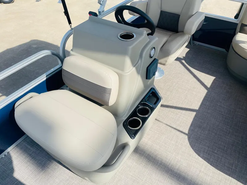 Slide: The Image of 2025 Sun Tracker Bass Buggy 16 XL Select boat interior with beige seating and steering console. - 14