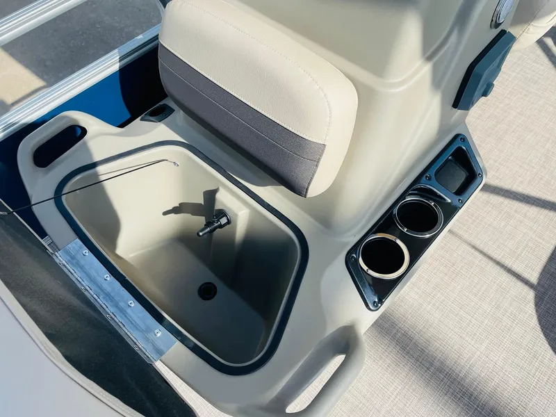 Slide: The Image of 2025 Sun Tracker Bass Buggy 16 XL Select boat interior with cup holders and storage compartment. - 15