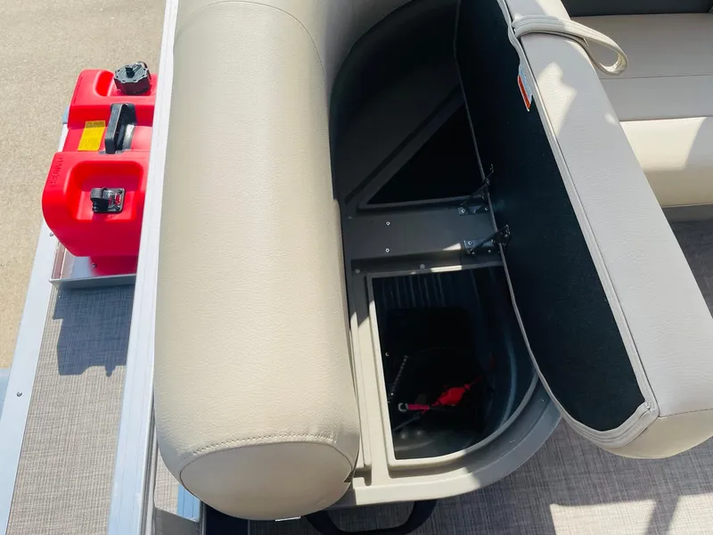 Slide: The Image of 2025 Sun Tracker Bass Buggy 16 XL Select storage compartment with red fuel containers. - 19