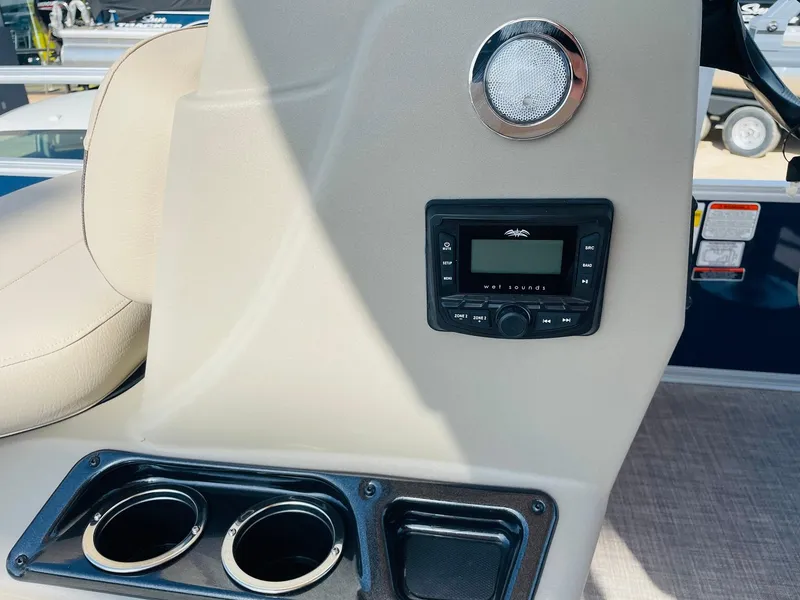 Slide: The Image of 2025 Sun Tracker Bass Buggy 16 XL Select console with stereo and cup holders. - 20