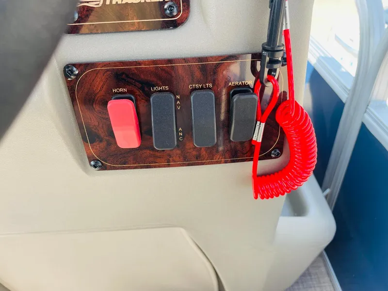 Slide: The Image of Control panel of 2025 Sun Tracker Bass Buggy 16 XL Select with switches and safety lanyard. - 23