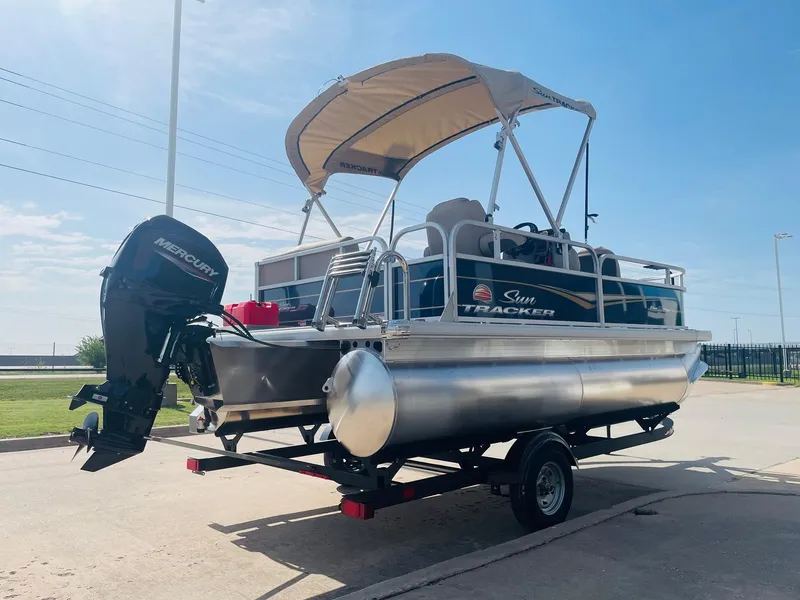 Slide: The Image of 2025 Sun Tracker Bass Buggy 16 XL Select pontoon boat on trailer. - 5