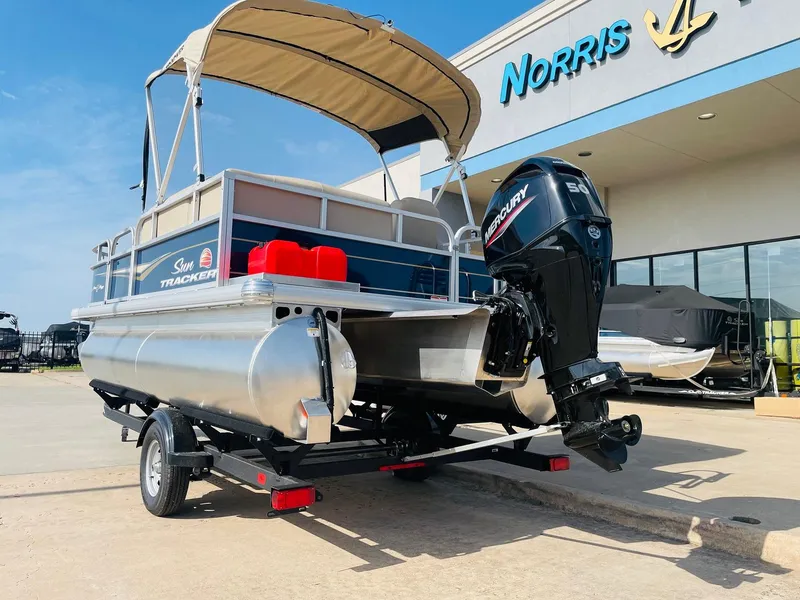 Slide: The Image of 2025 Sun Tracker Bass Buggy 16 XL Select pontoon boat with Mercury engine at dealership. - 8