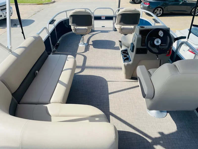 Slide: The Image of 2025 Sun Tracker Bass Buggy 16 XL Select pontoon boat interior with seating and steering console. - 9