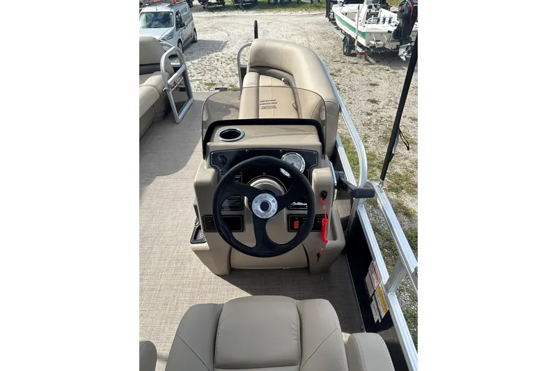Slide: The Image of 2025 Sun Tracker Party Barge 16 DLX pontoon boat interior with steering console. - 2