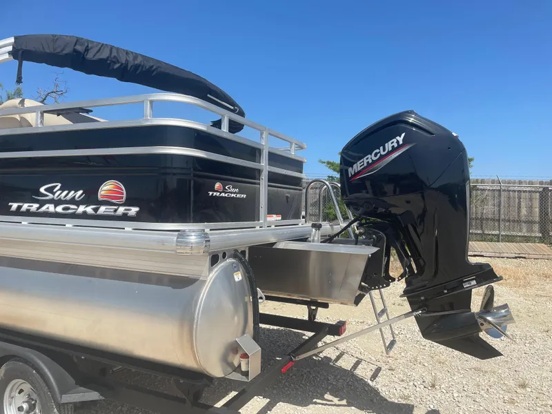 Slide: The Image of 2025 Sun Tracker SportFish 20 DLX pontoon boat with Mercury outboard motor. - 2