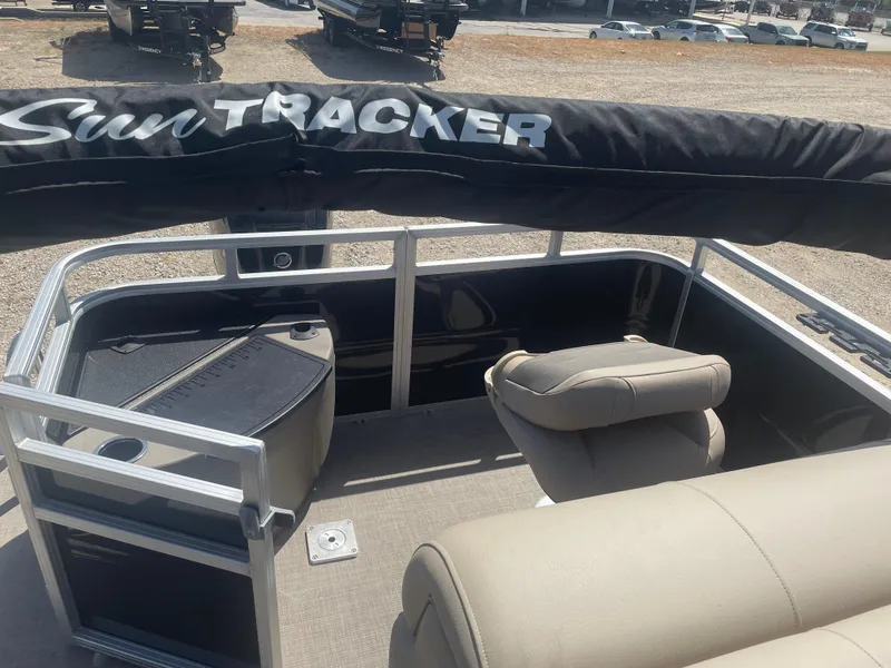 Slide: The Image of 2025 Sun Tracker SportFish 20 DLX pontoon boat interior with seating and storage. - 8