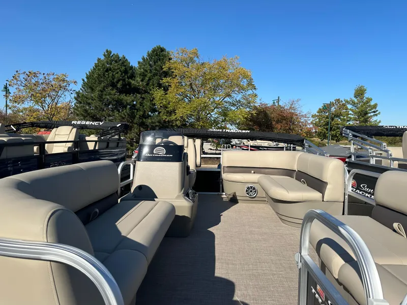 Slide: The Image of 2025 Sun Tracker Party Barge 16 DLX pontoon boat with spacious seating and scenic background. - 3