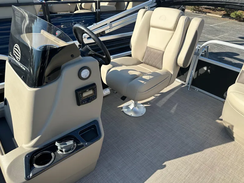 Slide: The Image of 2025 Sun Tracker Party Barge 16 DLX interior with captain's chair and control console. - 4