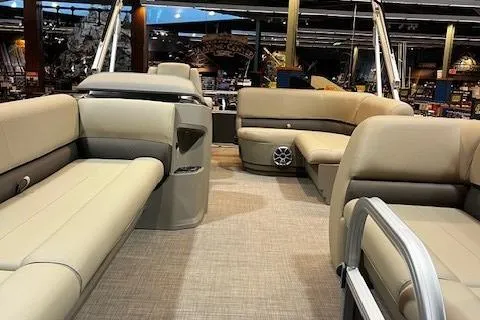Slide: The Image of 2025 Sun Tracker Party Barge 18 DLX interior with beige seating and spacious layout. - 2