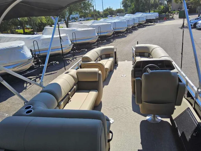 Slide: The Image of 2025 Sun Tracker SportFish 22 DLX pontoon boat interior with seating and steering console. - 3