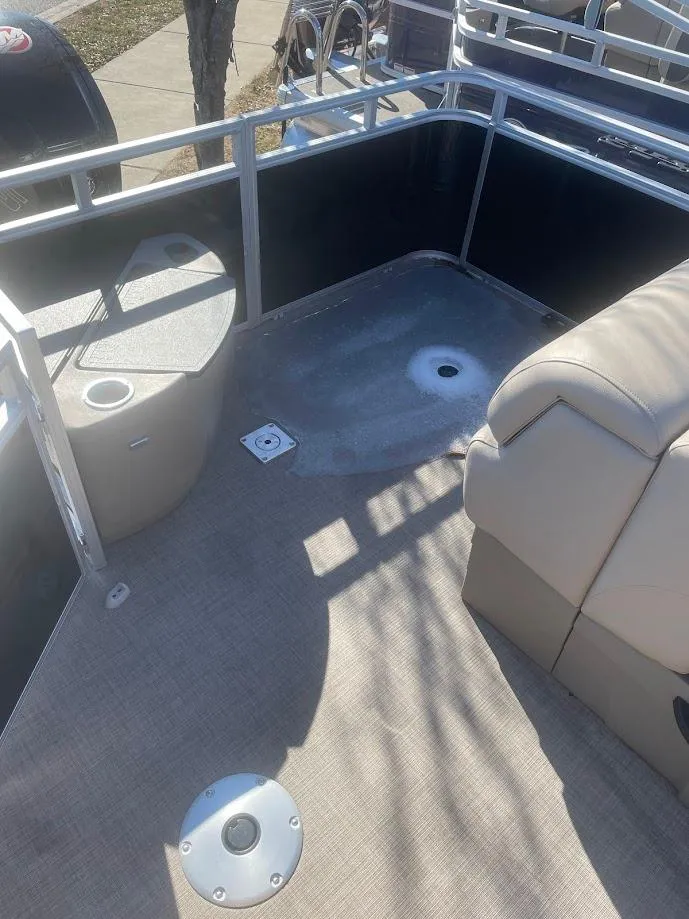 Slide: The Image of 2025 Sun Tracker SportFish 20 DLX boat interior with seating and railing. - 2