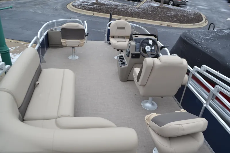 Slide: The Image of 2025 Sun Tracker Bass Buggy 18 DLX pontoon boat interior with beige seating. - 3