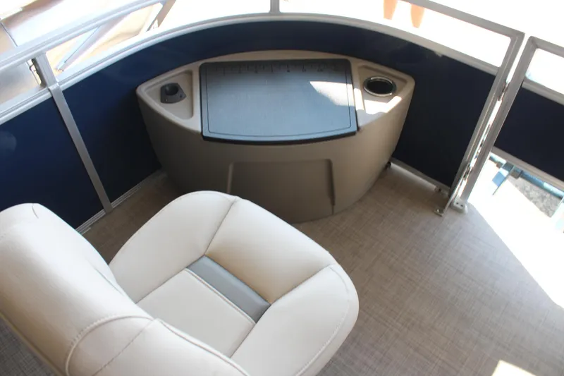 Slide: The Image of 2025 Sun Tracker Fishin' Barge 20 DLX interior with seating and console. - 11