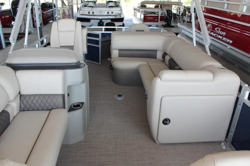 Slide: The Image of 2025 Sun Tracker Fishin' Barge 20 DLX interior with beige seating and spacious layout. - 14