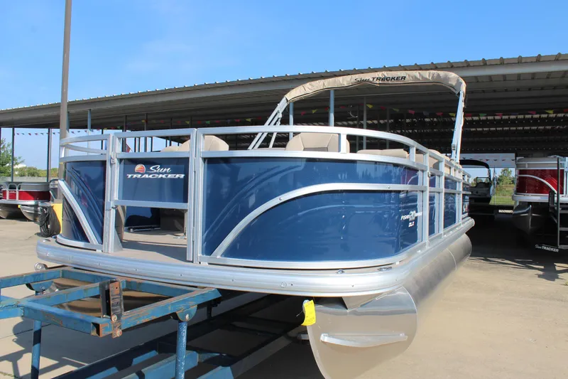 Slide: The Image of 2025 Sun Tracker Fishin' Barge 20 DLX pontoon boat in a marina setting. - 3