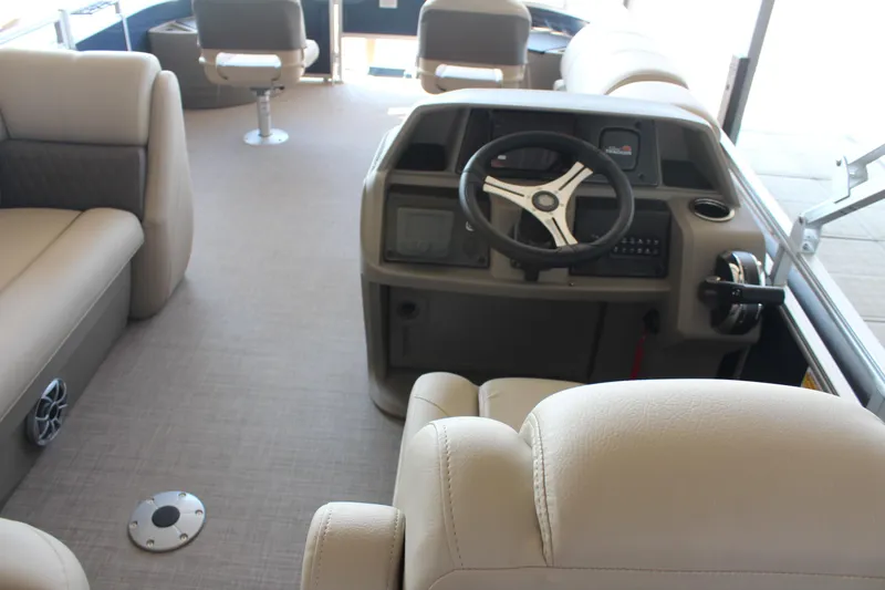 Slide: The Image of Interior of 2025 Sun Tracker Fishin' Barge 20 DLX, featuring steering console and seating. - 6