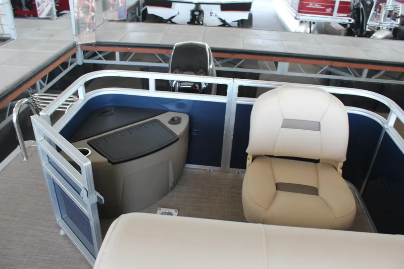 Slide: The Image of 2025 Sun Tracker Fishin' Barge 20 DLX interior with seating and storage. - 8