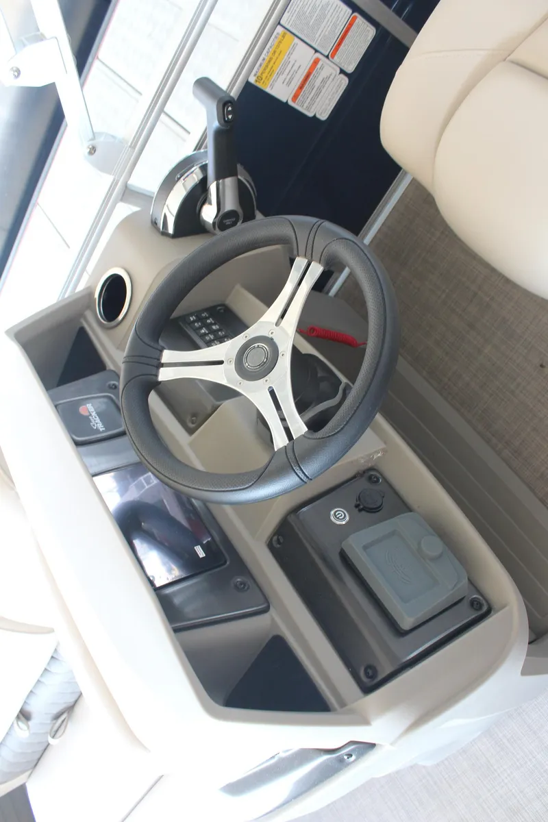 Slide: The Image of 2025 Sun Tracker Fishin' Barge 20 DLX steering console with modern controls and comfortable seating. - 9