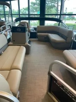 Slide: The Image of 2025 Sun Tracker Party Barge 16 DLX interior with beige seating and spacious layout. - 44