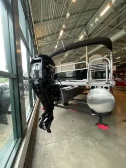 Slide: The Image of 2025 Sun Tracker Party Barge 16 DLX pontoon boat with outboard motor in showroom. - 45