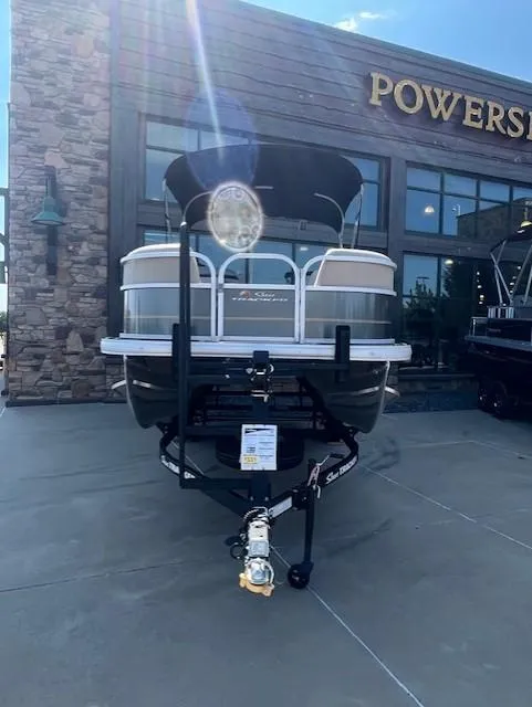 Slide: The Image of 2025 Sun Tracker Party Barge 18 DLX pontoon boat displayed outside dealership. - 2