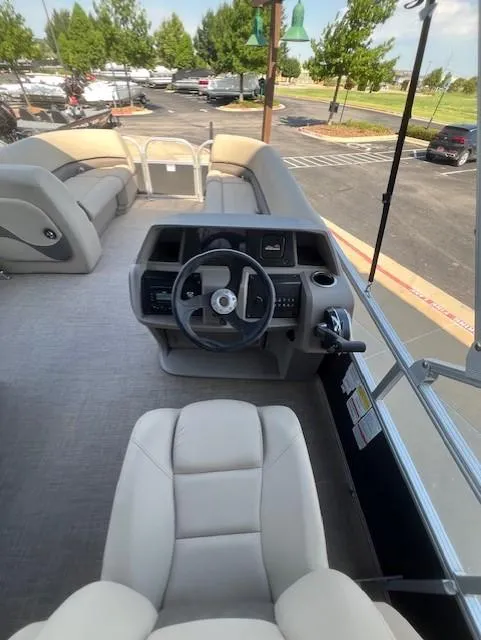 Slide: The Image of 2025 Sun Tracker Party Barge 18 DLX interior with steering console and seating. - 5