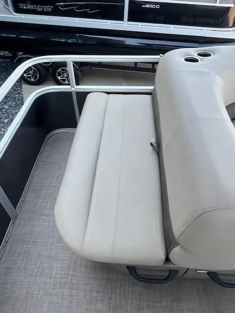 Slide: The Image of 2025 Sun Tracker Party Barge 18 DLX, beige seating, cup holders, modern design. - 6