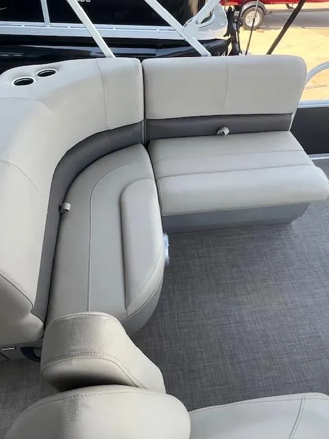 Slide: The Image of 2025 Sun Tracker Party Barge 18 DLX interior seating with gray upholstery and cup holders. - 7