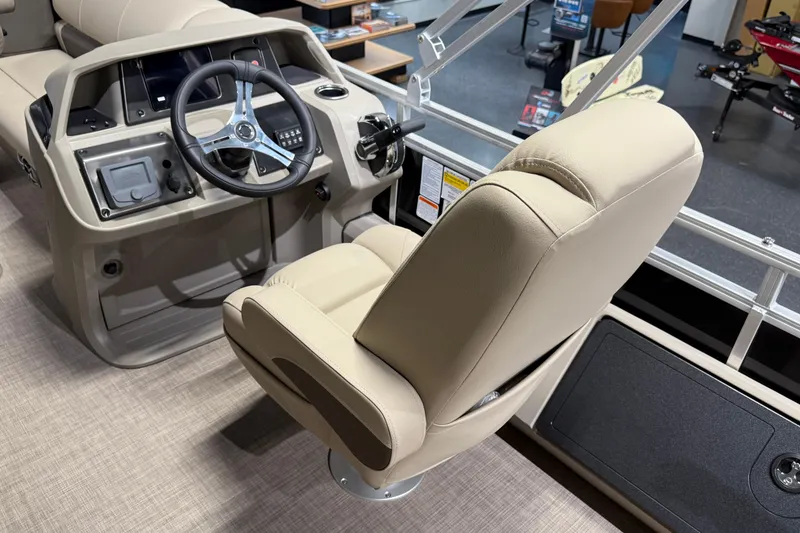 Slide: The Image of 2025 Sun Tracker Sportfish 24 XP3 boat interior with steering wheel and beige captain's chair. - 13
