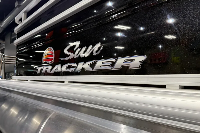 Slide: The Image of 2025 Sun Tracker Sportfish 24 XP3 logo on sleek black surface. - 27