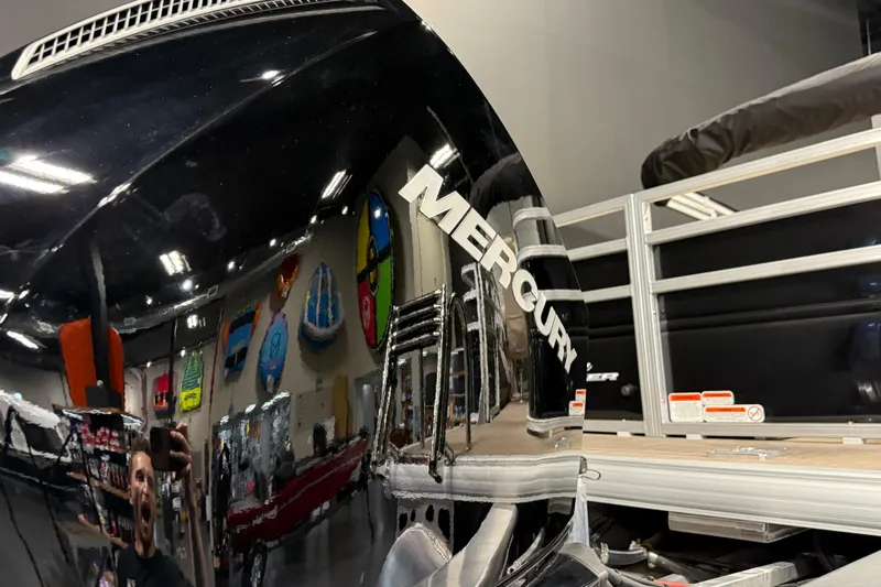 Slide: The Image of 2025 Sun Tracker Sportfish 24 XP3 with Mercury engine in showroom. - 5