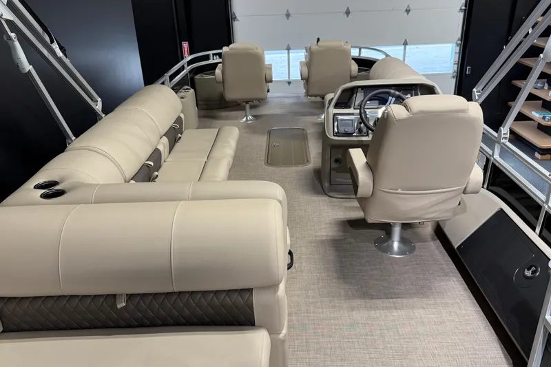Slide: The Image of 2025 Sun Tracker Sportfish 24 XP3 interior with beige seating and modern helm. - 8