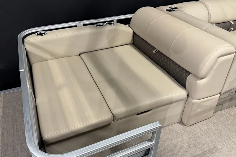 Slide: The Image of 2025 Sun Tracker Sportfish 24 XP3 boat seating with beige upholstery and cup holders. - 9