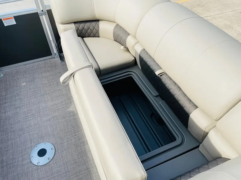 Slide: The Image of 2025 Sun Tracker Party Barge 22 RF DLX seating with storage compartment open. - 17
