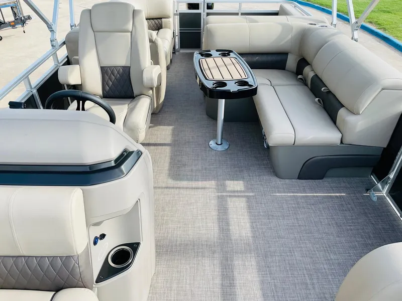 Slide: The Image of 2025 Sun Tracker Party Barge 22 RF DLX interior with plush seating and table. - 19