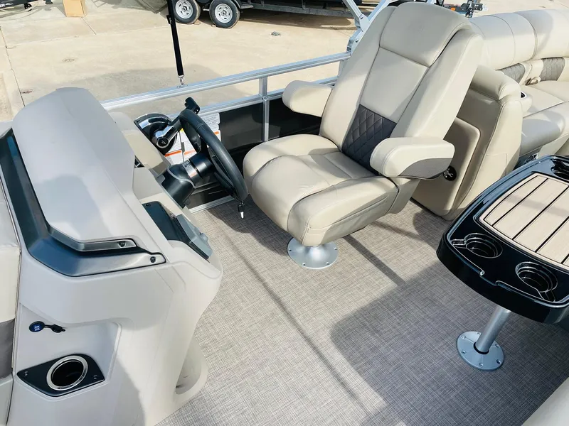 Slide: The Image of 2025 Sun Tracker Party Barge 22 RF DLX interior with captain's chair and console. - 20
