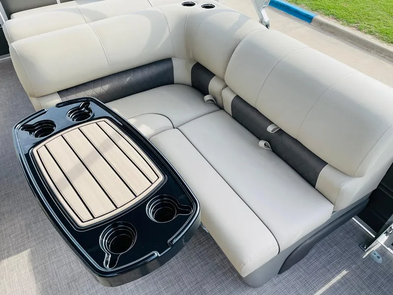 Slide: The Image of 2025 Sun Tracker Party Barge 22 RF DLX interior with plush seating and cupholders. - 21