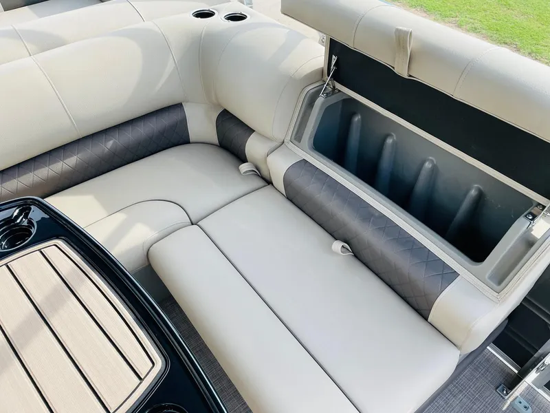 Slide: The Image of 2025 Sun Tracker Party Barge 22 RF DLX interior seating with storage compartment. - 22