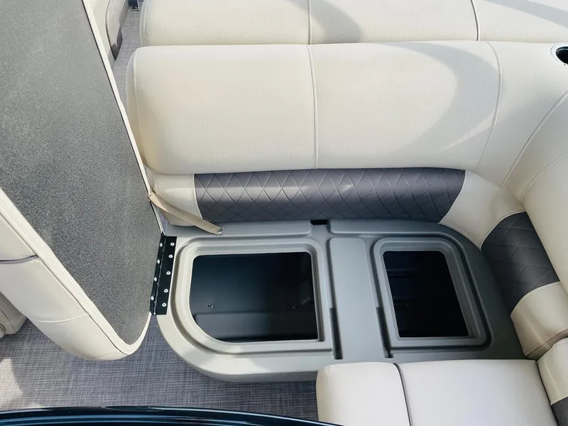 Slide: The Image of 2025 Sun Tracker Party Barge 22 RF DLX storage compartments and seating detail. - 24