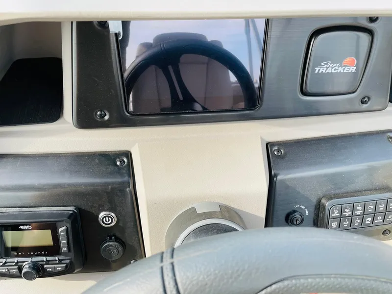 Slide: The Image of Dashboard of 2025 Sun Tracker Party Barge 22 RF DLX with steering wheel and controls. - 27