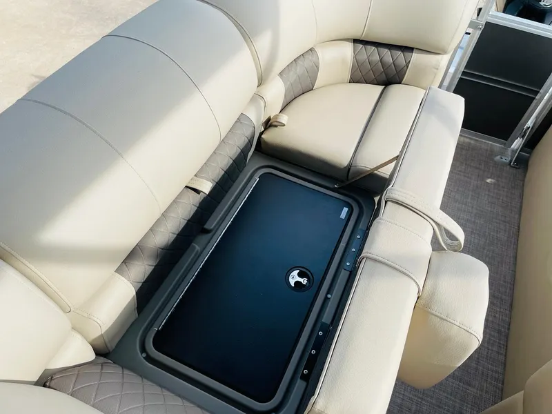 Slide: The Image of 2025 Sun Tracker Party Barge 22 RF DLX interior seating with storage compartment. - 31