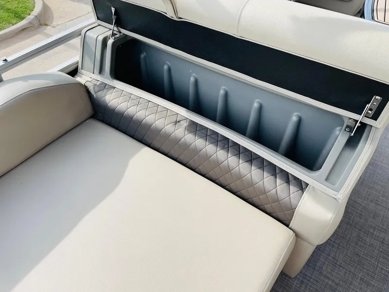 Slide: The Image of Sun Tracker Party Barge 22 RF DLX 2025 storage compartment with cushioned seating. - 35