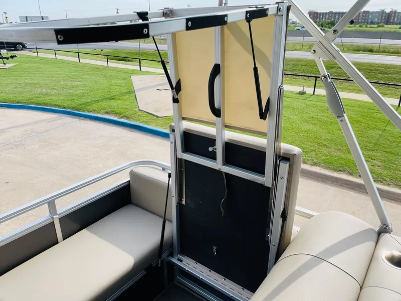 Slide: The Image of 2025 Sun Tracker Party Barge 22 RF DLX interior with seating and canopy frame. - 37