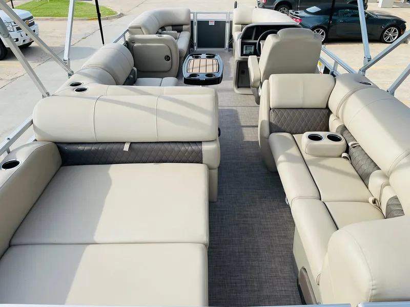 Slide: The Image of 2025 Sun Tracker Party Barge 22 RF DLX interior with plush seating and cup holders. - 9